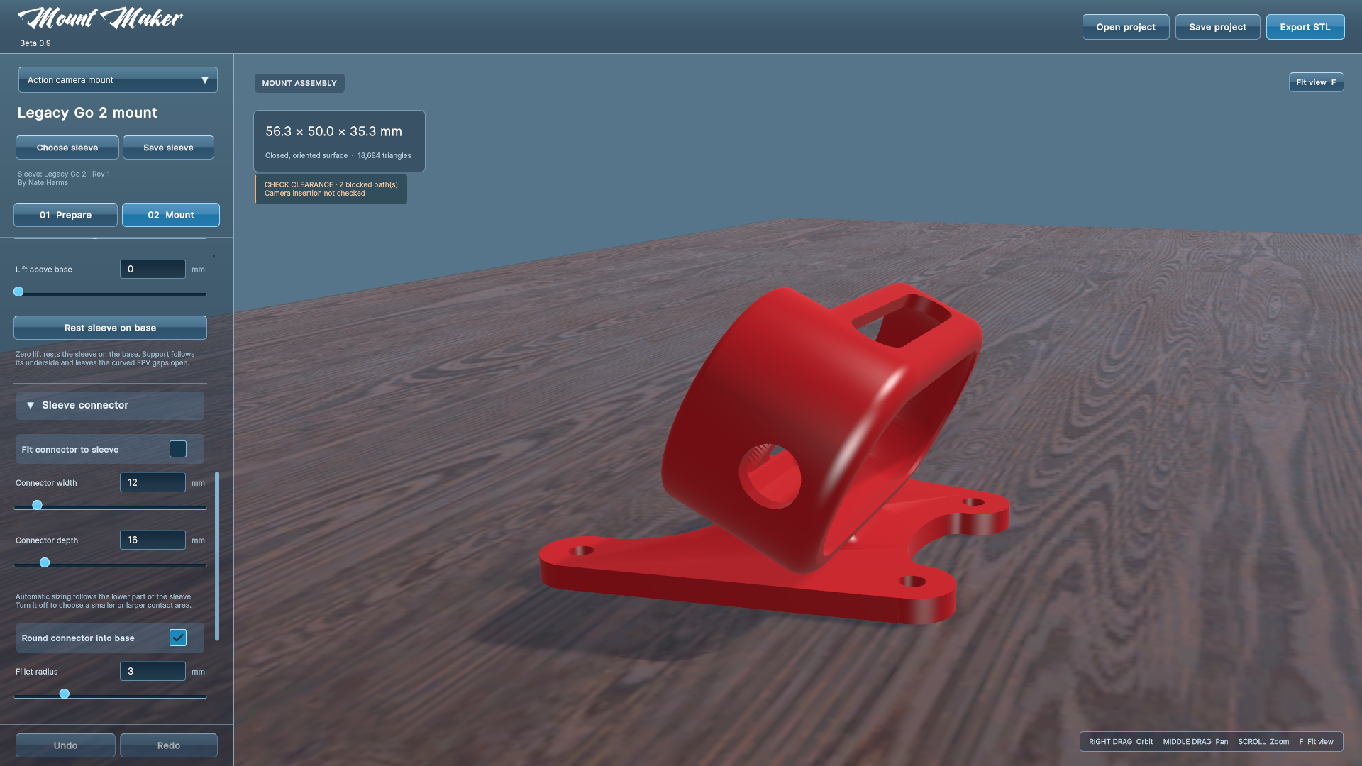 A red camera sleeve and rounded mount base in the rebuilt blue workbench
